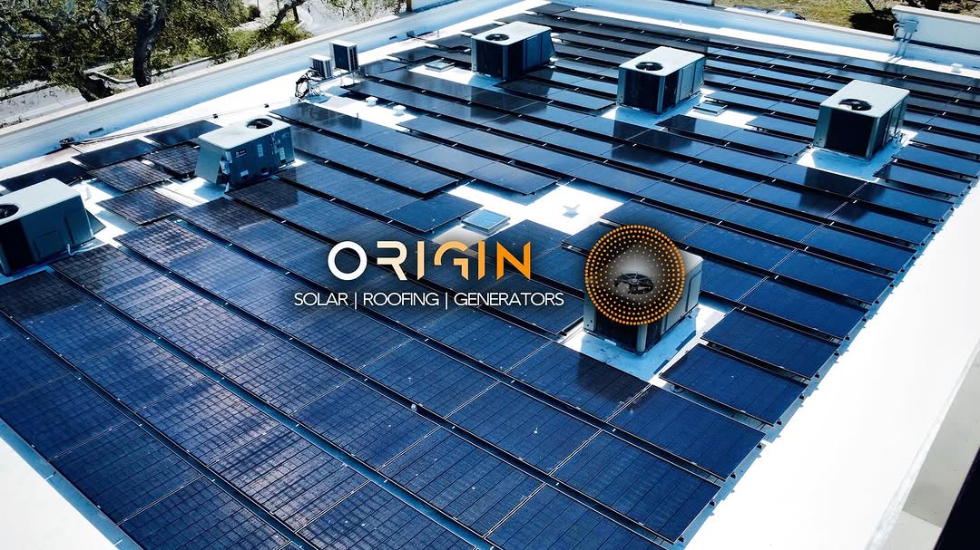 Rows of solar panels on a flat roof arranged around rooftop HVAC equipment