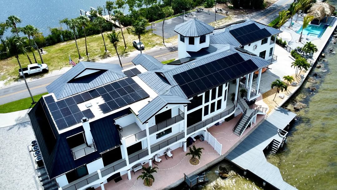 Solar arrays on multiple metal-roof sections of a waterfront building